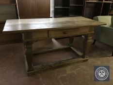 An early twentieth century continental oak library table fitted a drawer