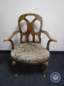 A Victorian walnut tapestry upholstered armchair on cabriole legs