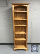 A set of narrow pine bookshelves