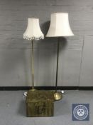 Two brass standard lamps with shades and a brass embossed coal receiver