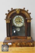 An American beech cased mantel clock with enamelled dial
