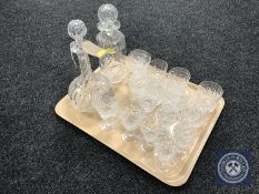 A tray containing assorted lead crystal drinking glasses together with two lead crystal decanters