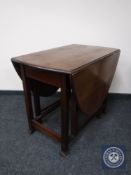 An oak gate leg table and an occasional table