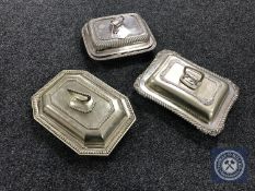 Three plated entree dishes with covers