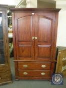 A contemporary hardwood double door hanging wardrobe fitted two drawers