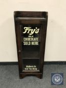 An Edwardian and later glazed oak cabinet with Fry's Chocolate decoration, width 36 cm.