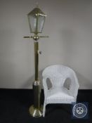 A painted wicker armchair together with a standard lamp in the form of a street light