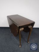 A mahogany gate leg table on club feet