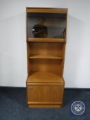 A mid 20th century teak S-Form display unit fitted cupboards beneath