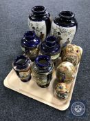 A tray containing six Japanese vases together with a set of three graduated Japanese eggs depicting