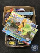 Two boxes of assorted toys including die cast vehicles, Thomas the Tank Engine rails, postcards,