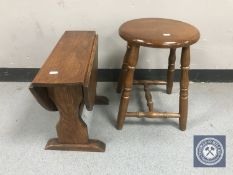 A small oak drop leaf occasional table together with a stool