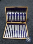 A mahogany canteen containing a 12 setting knife and fork service