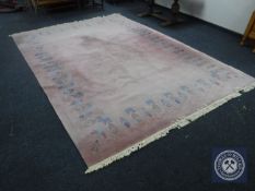 A pink fringed woollen carpet,