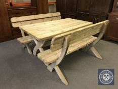 A pine garden table on X-frame support plus two benches