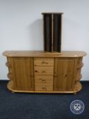 A contemporary D-shaped pine sideboard together with a pine CD rack