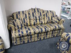 A three-piece lounge suite upholstered in Regency style striped fabric