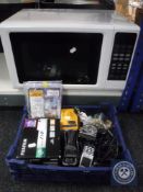 A Kenwood microwave together with a box containing mobile phone, darts etc.