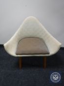 A mid twentieth century upholstered basket chair on teak legs