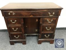 A George III mahogany kneehole pedestal desk, width 95 cm.