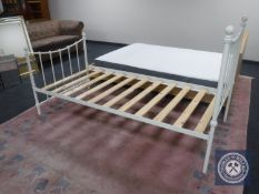 A white metal 3' bed frame