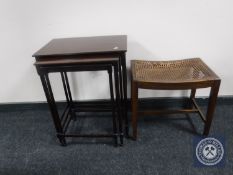 A nest of three mahogany tables together with a mahogany bergere seated dressing table stool