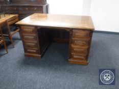 An early twentieth century oak twin pedestal desk