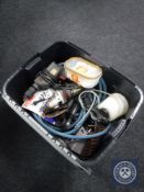 A plastic crate containing power tools,