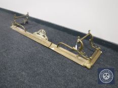An early 20th century brass extending fire curb together with a brass jug