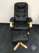 A pine framed black leather swivel relaxer chair with stool