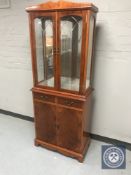 A yew wood display cabinet fitted double door cupboards and two drawers beneath CONDITION
