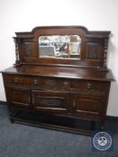 An early twentieth century oak mirror backed sideboard