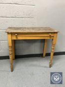 An antique pine side table fitted a drawer