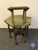 An Eastern octagonal folding brass top table and a rustic stool