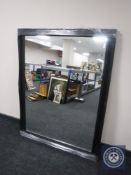A black framed overmantel mirror