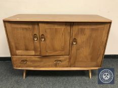 An Ercol elm sideboard, width 115 cm.