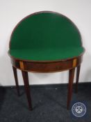 A George III inlaid mahogany demi lune games table