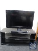 A Toshiba 32 inch LCD TV on stand