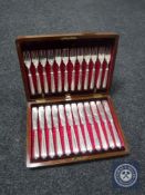 A mahogany canteen containing fish cutlery (12 settings)