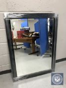 A glass framed two-tone overmantel mirror