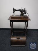 An oak cased vintage Singer hand sewing machine together with an oak barley twist occasional table