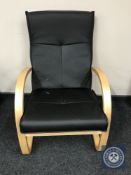 A pine framed black leather armchair