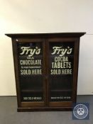 A Victorian glazed door bookcase bearing Fry's Chocolate advertising