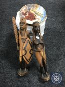 Eight John Wayne collector's plates with certificates and two carved tribal figures