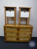 A pine and wicker six drawer chest and a pair of pine bedside cabinets