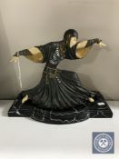 A contemporary Art Deco style figure of a dancer on a shaped marble effect base