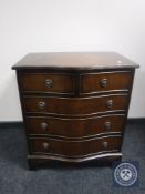 A mahogany serpentine fronted five drawer chest on bracket feet retailed by Chapmans