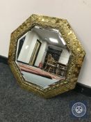 An embossed brass bevelled mirror,