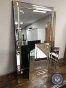 A glass framed overmantel mirror and a glass triple dressing table mirror