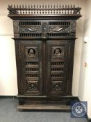 A nineteenth century continental carved oak two door cabinet,